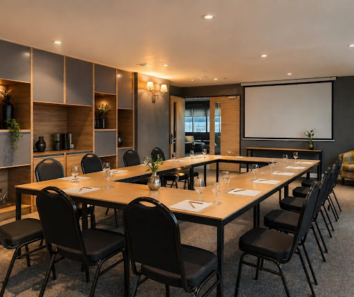 Modern sunlit conference room at Brittany Hotel BGC with urban city views