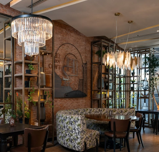 A high-end, sustainable boutique hotel lobby in Manila featuring lush greenery and natural wood textures