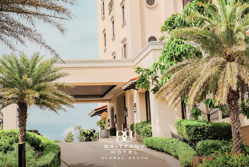A serene wide-angle shot of a luxurious modern hotel facade during the soft golden hour of a September afternoon